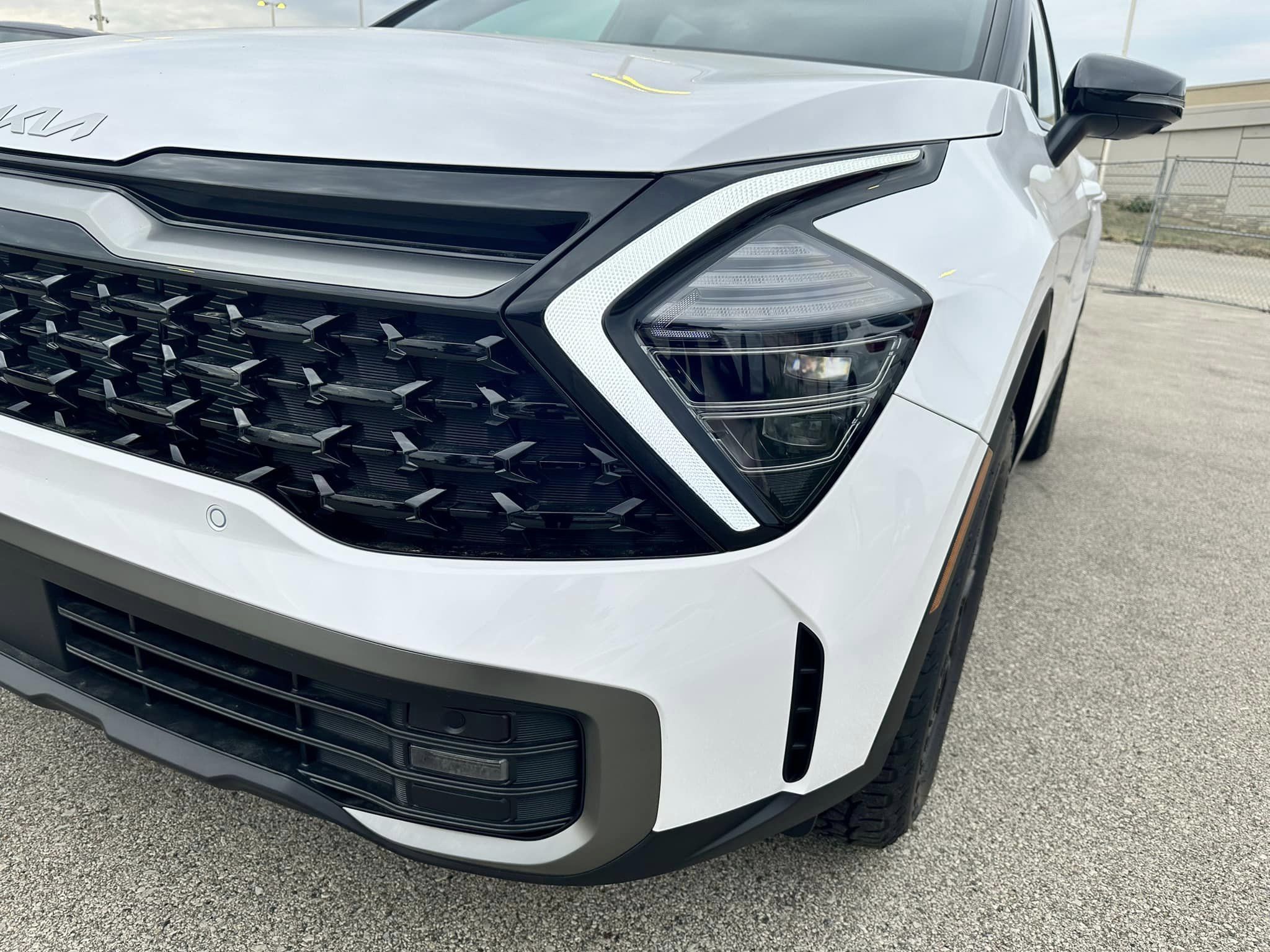 2024 Kia Sportage - Glacial White Pearl - X-Pro Prestige Trim - Driver Front Close Up View